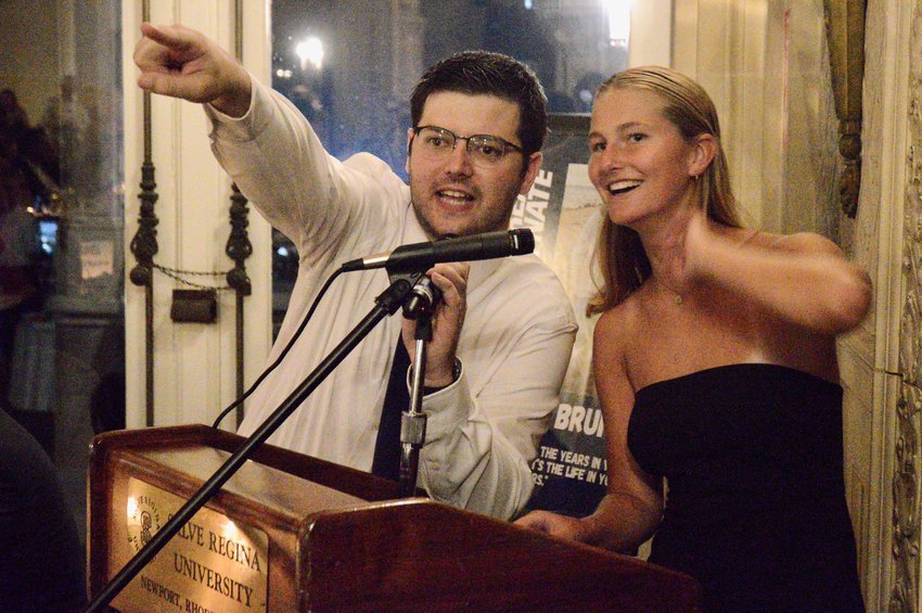 Steven Peterson, executive director for Be Great for Nate, and Anna Conheeny, a senior member of Every Student Initiative (ESI), recognize a bidder during the live auction at the Be Great for Nate Fundraising Gala at Ochre Court in Newport.