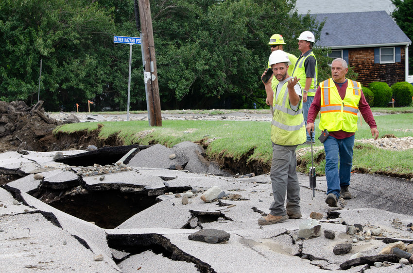 A town worker looks over the lower portion of Fairview Lane after the street collapsed early Thursday morning.