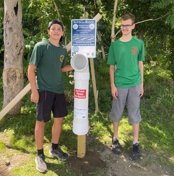 Nathan Simas of Bristol with friend Nathan Dieterich. Simas built five fishing line receptacles as part of his Eagle Scout journey.