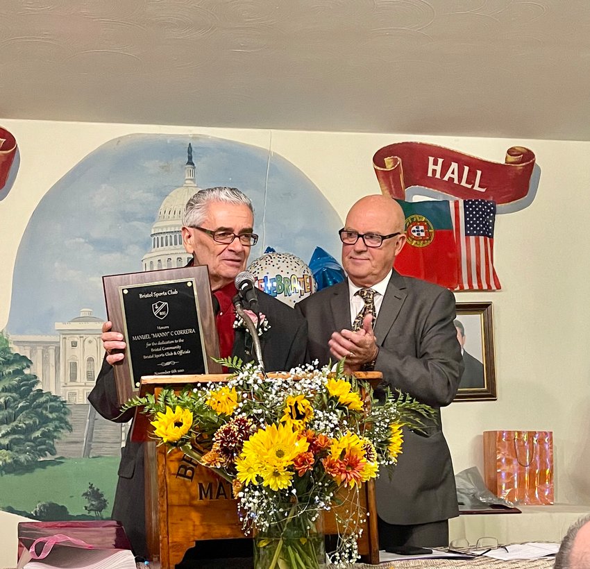 Manuel C. &ldquo;Manny&rdquo; Correira accepts the Man of the Year plaque from Bristol Sports President Elisio Castro, shortly before the unveiling of his portrait, which hangs proudly in the sports club&rsquo;s banquet hall on Wood Street.