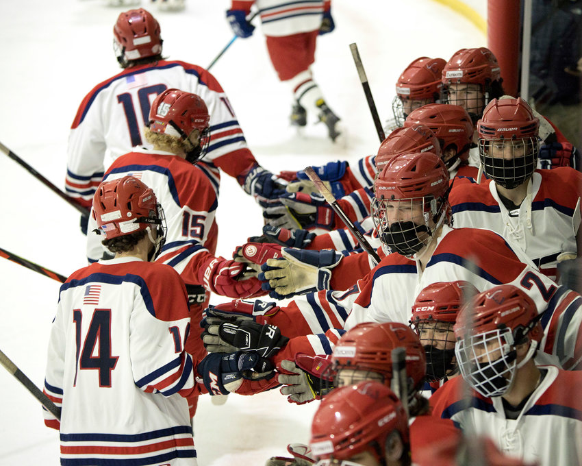 Members of the Portsmouth High boys&rsquo; hockey team celebrate their Injury Fund victory over Barrington on Sunday.
