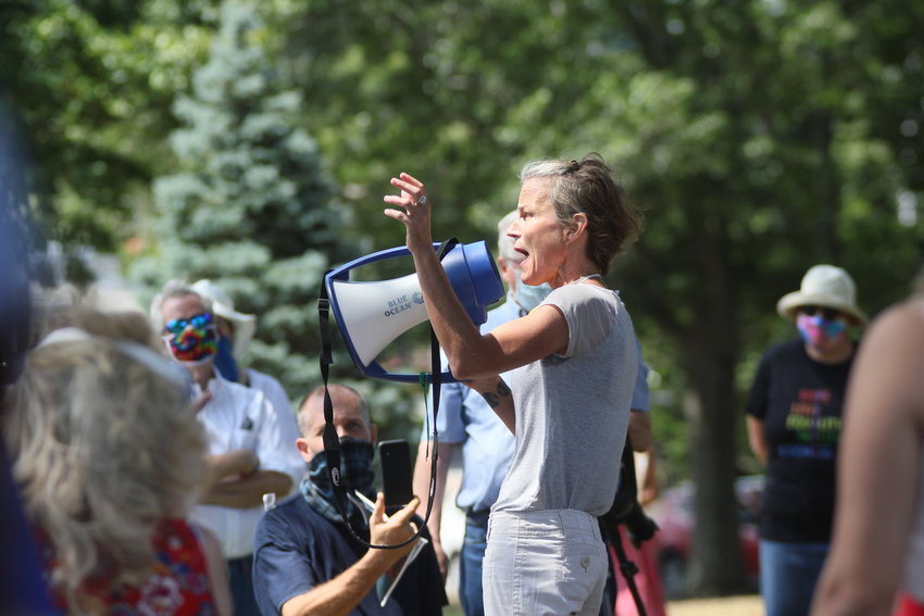 Barrington resident Katherine Quinn is shown speaking during a rally outside the town hall last year. She recently applied to serve on the town's zoning board, but said the council intentionally blocked her from getting appointed.