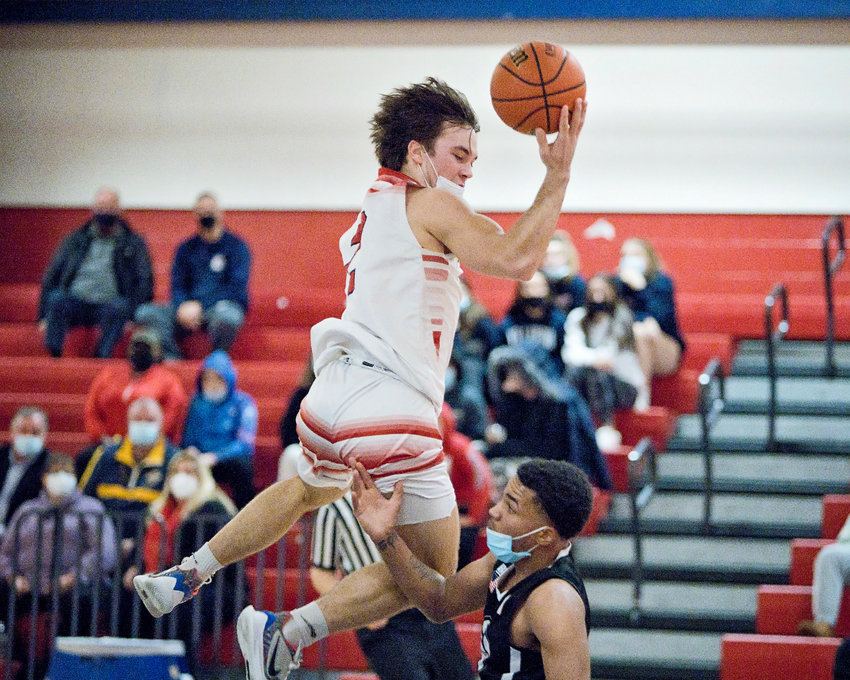 Portsmouth High&rsquo;s Benny Hurd soares over a Mount Pleasant opponent during the Patriots&rsquo; home game Friday night. Hurd was the high-scorer for the Patriots with 20 points, but Portsmouth lost, 57-51.