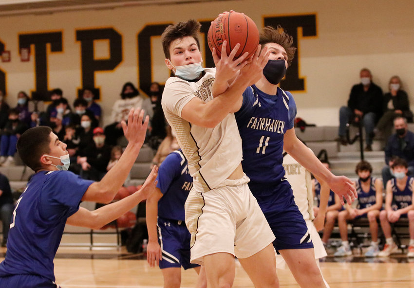 Senior forward Aidan Rock pulls down a rebound in the first quarter of the Wildcats game against Fairhaven on Friday night. Westport won, 56-50.