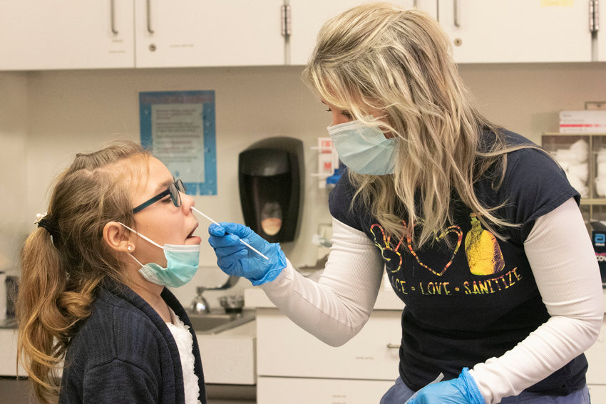 Colt Andrews Elementary School Nurse Julie Pirri&nbsp;tests fourth-grader Emma Gray for Covid at the school the week before Christmas vacation.