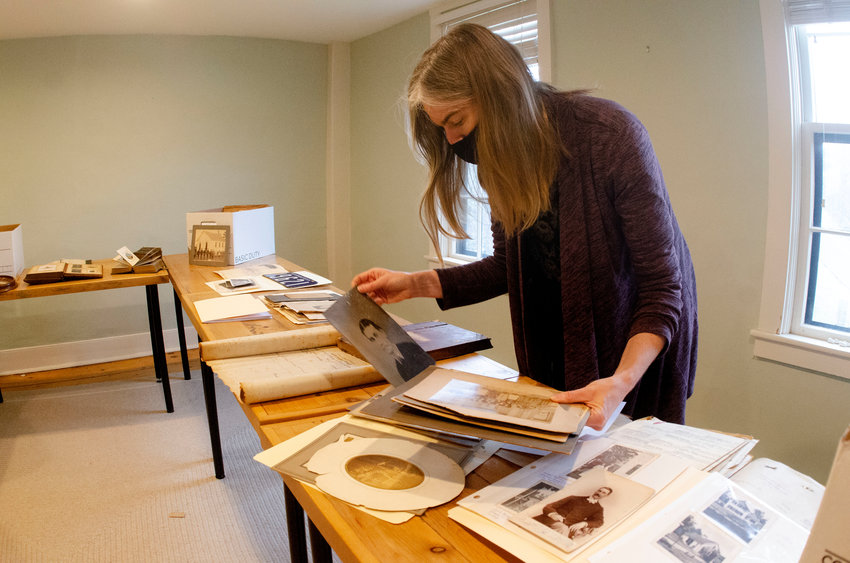 Westport Historical Society executive director Jenny O'Neill looks through part of the Sherman Collection one recent morning