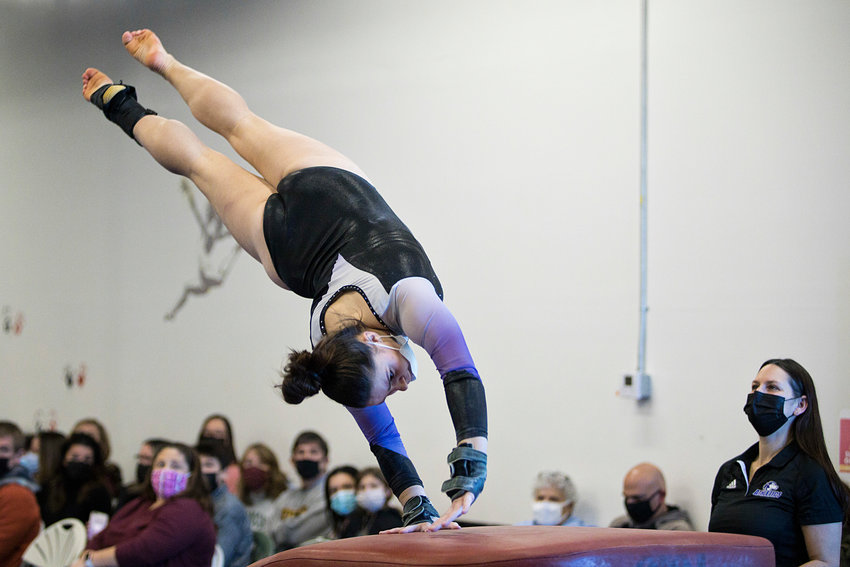 Reese Pavao competes on vault, earning an 8.5 during a late-January meet against Portsmouth, Rogers/EP, and Middletown.