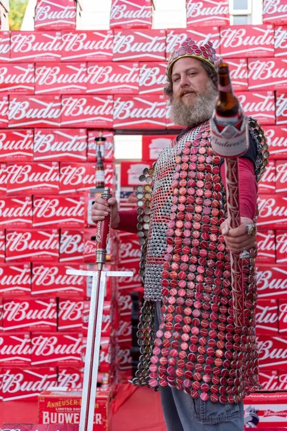 Paul Castro, a Warren resident and Swansea native, stands before a castle made of Budweiser cases decked in his full Budweiser regalia &mdash; a bottle cap cape, can tab chainmail, cap crown, bottle scepter and a sword with a Budweiser tap hilt. The elaborate costume has earned him notoriety as the winner of Budweiser&rsquo;s 2021 King of Buds contest.