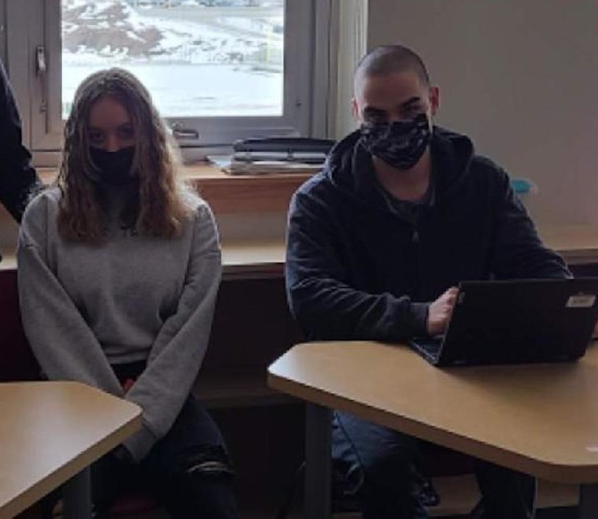 East Providence High School students Gabrielle Phaneuf and Brett Nardowski wear their masks while attending classes on March 1. When students return to the building on March 7, the indoor mask mandate for schools will have been rescinded.