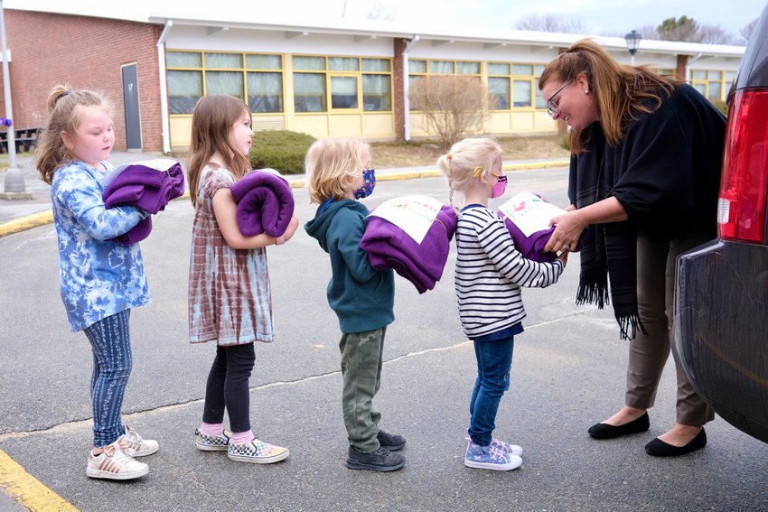 Hathaway School students hand over their &ldquo;Blankets of Hope&rdquo; Monday morning to Heather Strout, executive director of the Dr. Martin Luther King, Jr. Community Center, for distribution to homeless people.