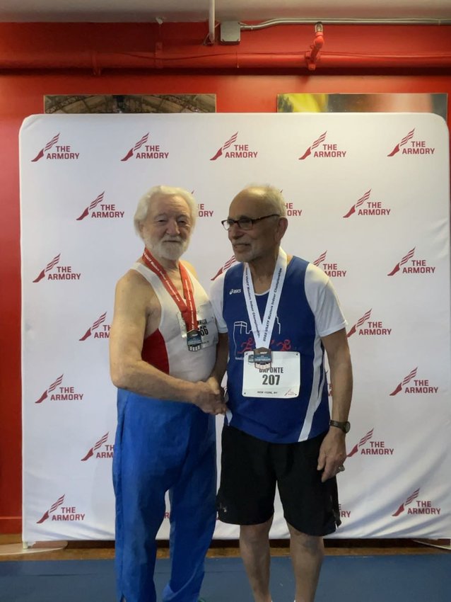 Anthony DaPonte, sporting his bronze medal, shakes hands with silver medalist 85-year-old Spencer Parish following the 200-meter run at the Masters National Indoor Championship on March 20.