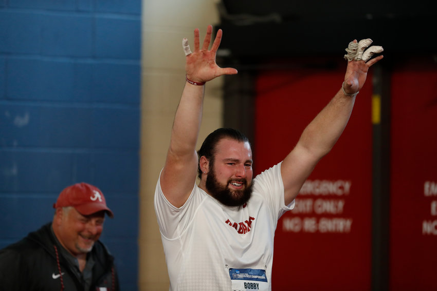 Barrington native Bobby Colantonio, a junior at the University of Alabama, raises his hands in the air after winning the weight throw at the NCAA Indoor Track National Championship meet.