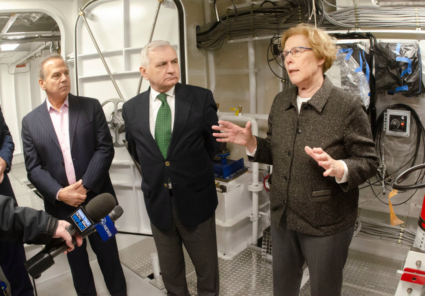 Congressman David Cicilline and Senator Jack Reed look on as Blount Boats, Inc. president Marcia Blount shows off the engine room of a Blount-built ice cutter commissioned by the State of Maryland.