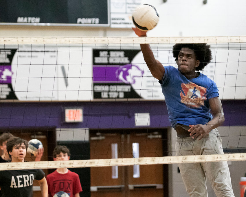 Basketball champ Rick Julien is slated to play middle hitter for the Huskies volleyball team this season.