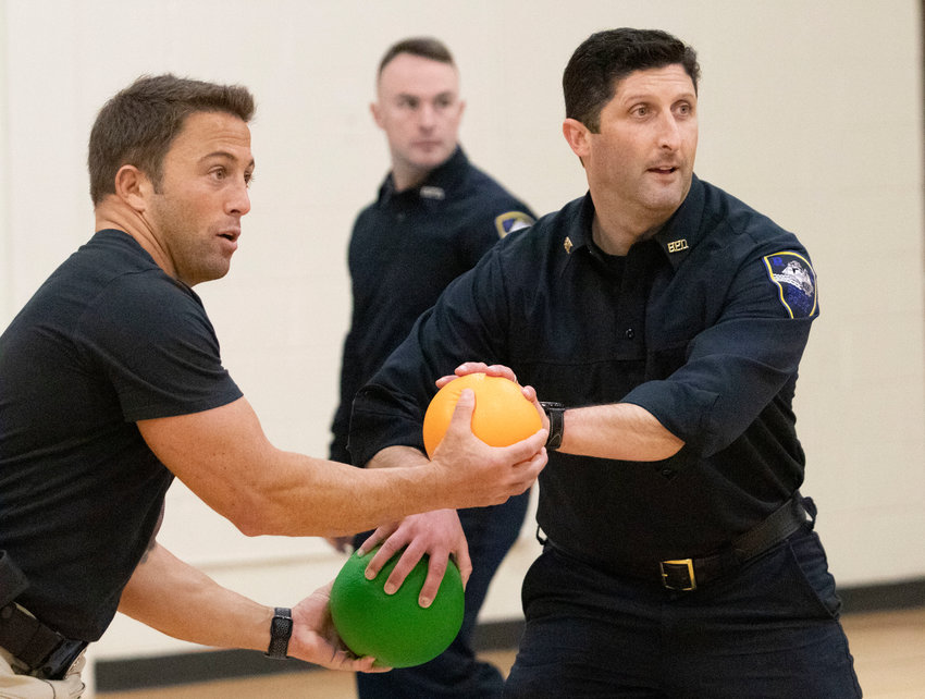 Bristol Police officers Keith Medeiros (left) and Lt. Steven St. Pierre make a plan of action as the dodgeball game begins.