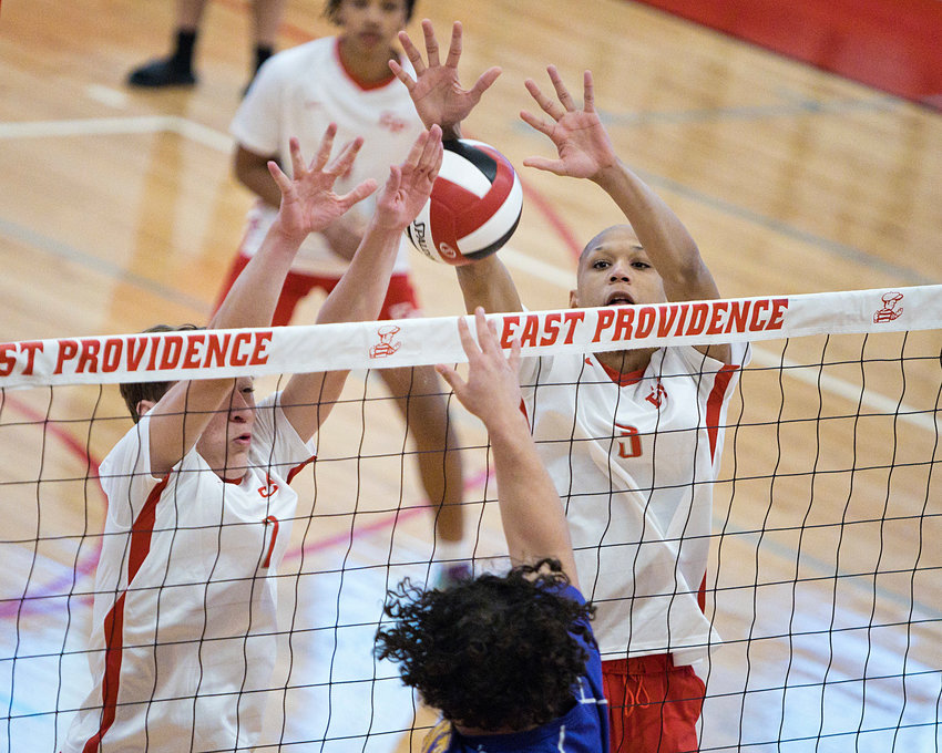 East Providence High School&rsquo;s DJ Lepine (left) and Jayden Cadwell attempt to block a St. Raphael shot from coming over the net during the boys&rsquo; volleyball Injury Fund exhibition between the teams Friday night, April 1.