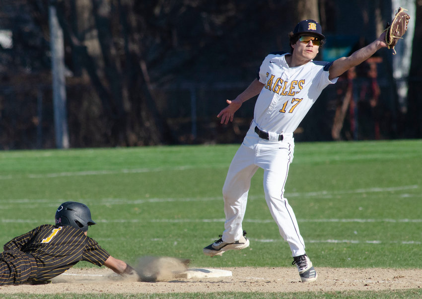 Barrington High School first baseman JC Neimeyer reaches for a throw during the Eagles game against Central on Tuesday.