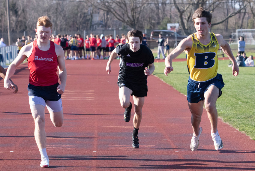 Barrington High School's Nate Greenberg (right) crosses the finish line just ahead of Portsmouth's Colby Fahrney (left) in the 100-meter race.