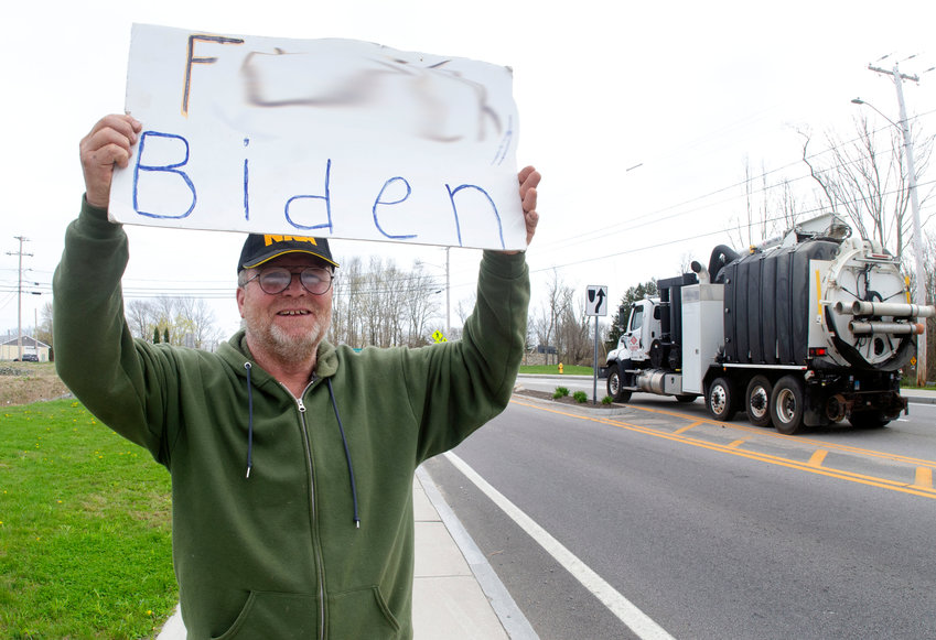 Tiverton Budget Committee member Joseph Sousa protests against President Joe Biden Monday in front of Stateline Tobacco on Stafford Road. Note: portions of his sign have been blurred electronically.