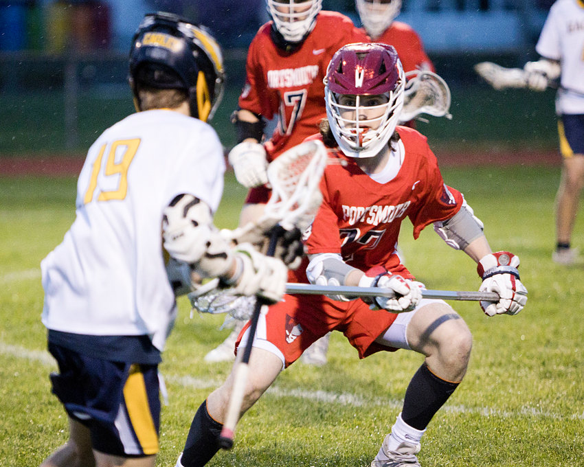 PHS defender Joe Rocco pressures his Barrington opponent near the goal Friday night. By the end of the first quarter, the Patriots had already secured a 7-0 lead against the Eagles and went on to win 10-7 for their fourth straight victory.