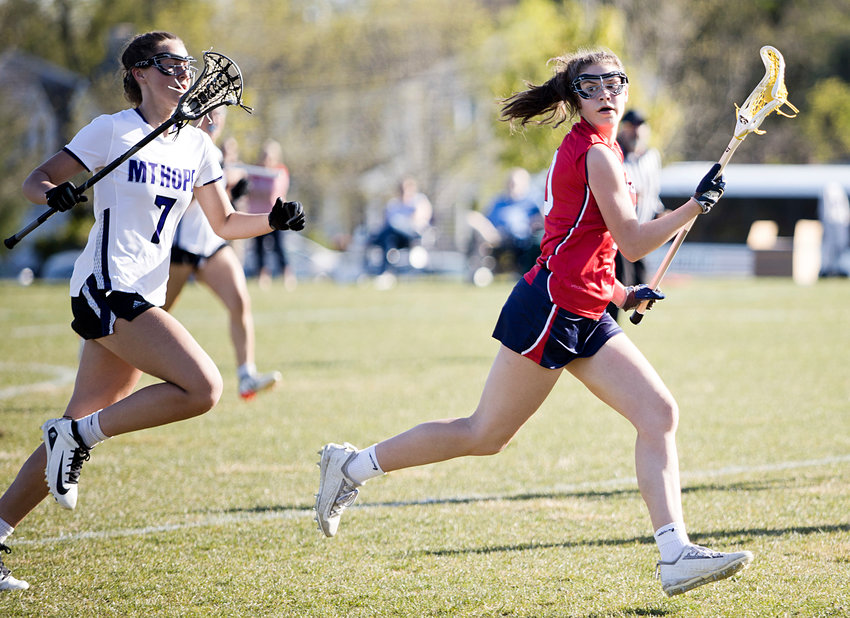 Portsmouth High&rsquo;s Kaitlin Roche checks to see how close her Mt. Hope opponent is while in possession of the ball during Thursday&rsquo;s game won by the Patriots, 17-3. Roche scored two goals during the game.