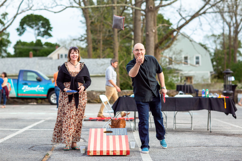 Jen and Jay Rainone enjoy a game of cornhole at the Bristol Warren Education Foundation&rsquo;s first in-person fundraiser since 2019.