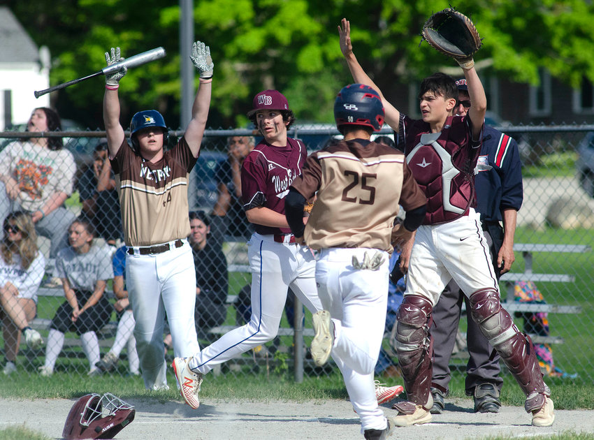 Connor James (left) signals teammate Nick Arruda to stay up as he crosses home plate in the third inning of their game against West Bridgewater on Tuesday. Westport won the home game 7-6.
