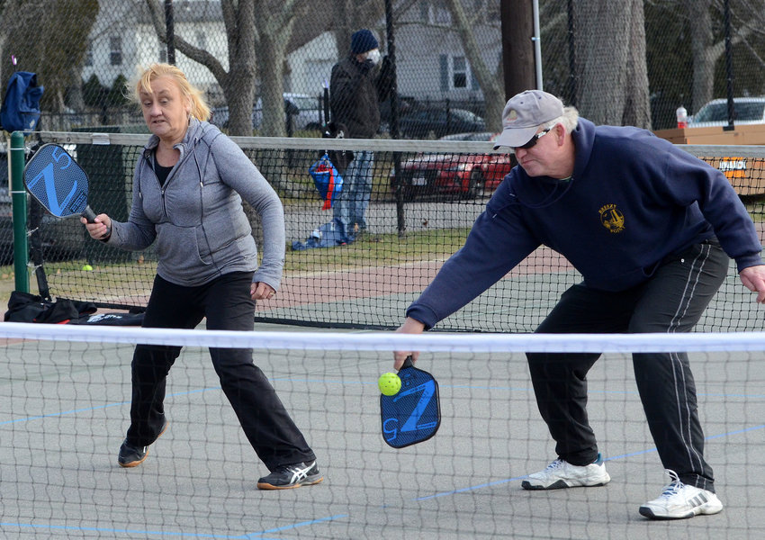 Cathy Winston looks on as teammate David Schwartz returns a serve during a game of pickleball on the Bristol Town Common. The Town of Portsmouth&rsquo;s grant request for matching funds to build a pickleball facility at Elmhurst Park was recently denied.
