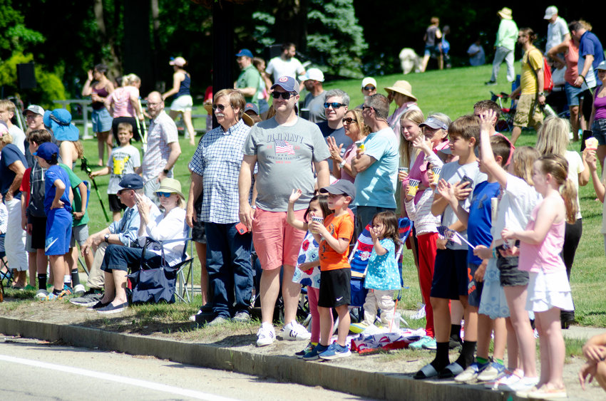 A crowd cheers on a previous year's parade in front of the Barrington Town Hall.