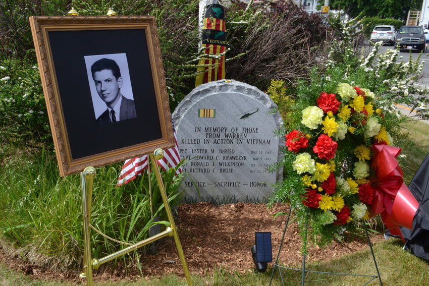 A photo of Sgt. Ronald Wilkinson seen at the memorial site, next to the stone which also honors Lester DeRiso, Edward Krawczyk, and Richard Brule, all residents of Warren who lost their lives during the Vietnam War.