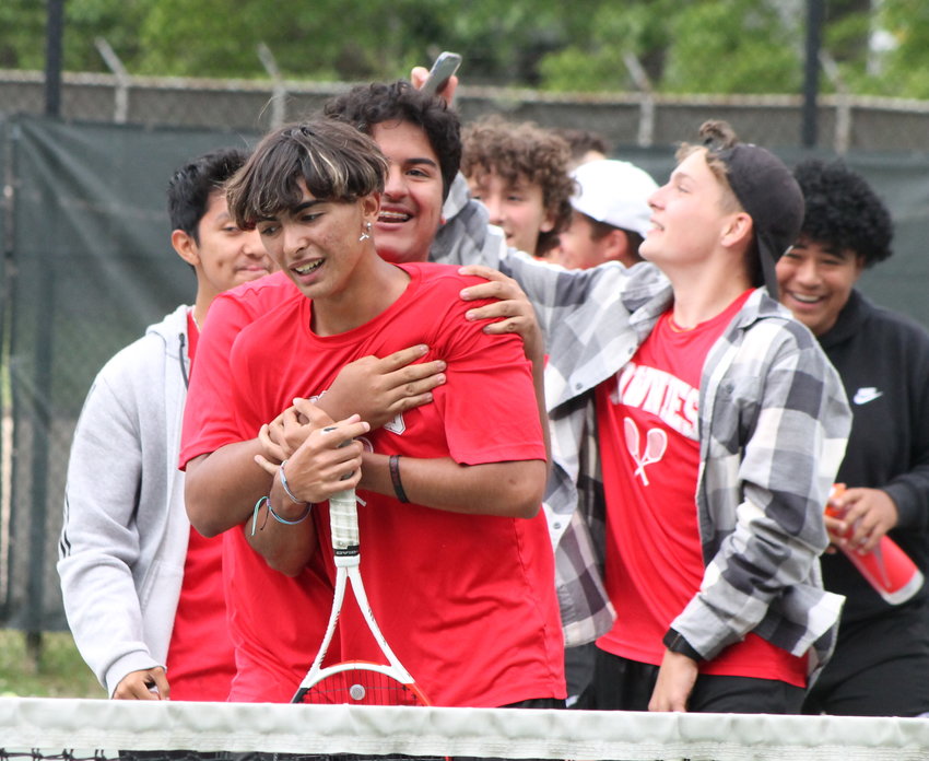 Jordan O'Hara is embraced by his EPHS tennis teammates after he earned the deciding point in the Townies' Division III semifinal round win over PCD Wednesday, June 1.