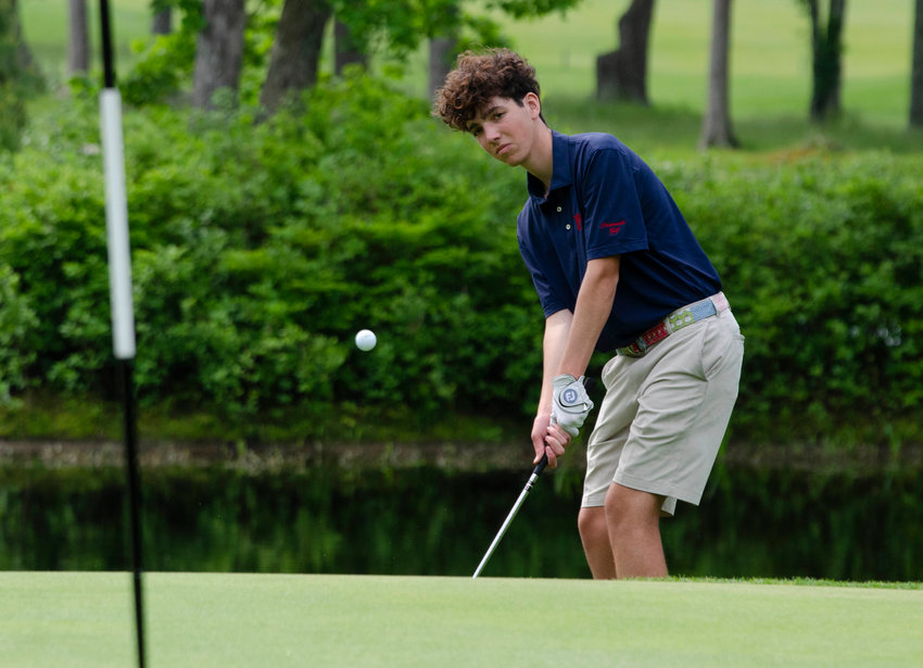 Portsmouth High&rsquo;s Ronan Caufield chips onto the green while playing the back nine during the state team championships at Cranston Country Club earlier this week.