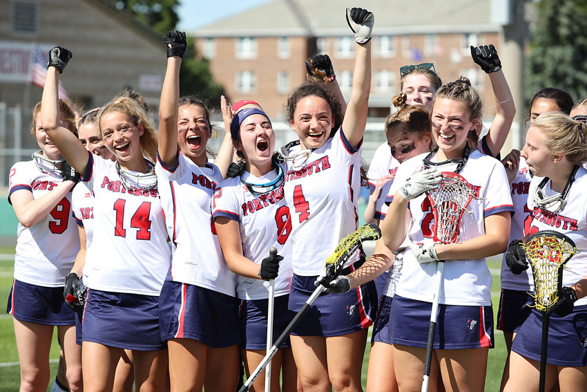 Members of the Portsmouth High School girls&rsquo; lacrosse team celebrate after beating Burrillville, 14-4, to capture the Division II state crown at Cranston Stadium on Sunday.