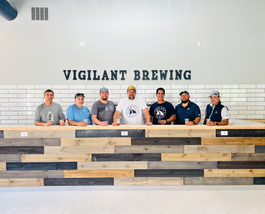 Chris Drance, Larry Medeiros, Michael Godet, Joe Dacosta, John Otero, Kevin Amaral, and Luis Medeiros pose in the taproom at Vigilant Brewing, which is slated to open at the end of June in Bristol.