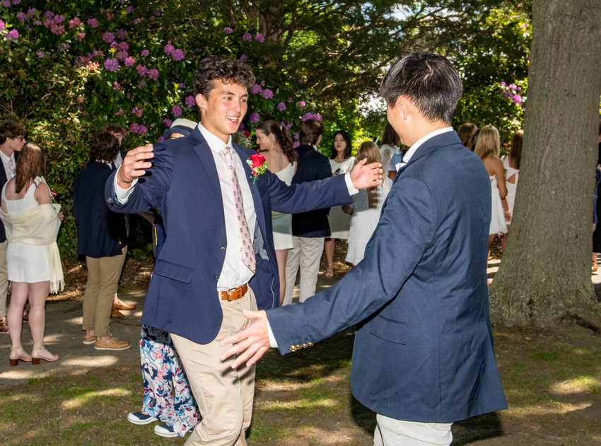 Davis Lee of Portsmouth congratulates a classmate at the conclusion of Portsmouth Abbey&rsquo;s commencement exercises on Sunday, May 28.