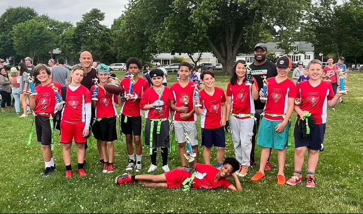 The Bucs captured the Barrington Flag Footballl 12U Division Championship on Sunday. Mike Tarasenko (back, left) and Jay Cameron (back, right) coached the Bucs.