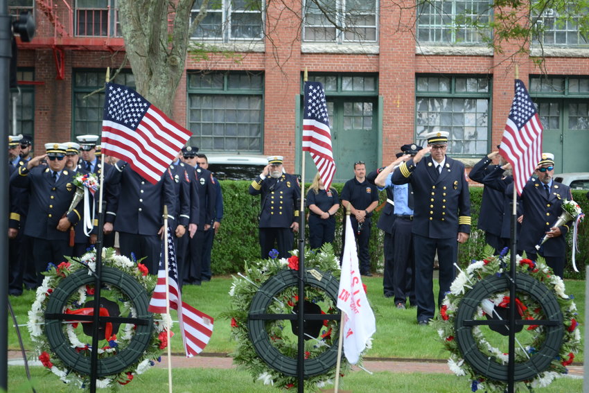 Firefighters salute during the wreath dedication ceremony at Firemen&rsquo;s Memorial Park on Sunday.