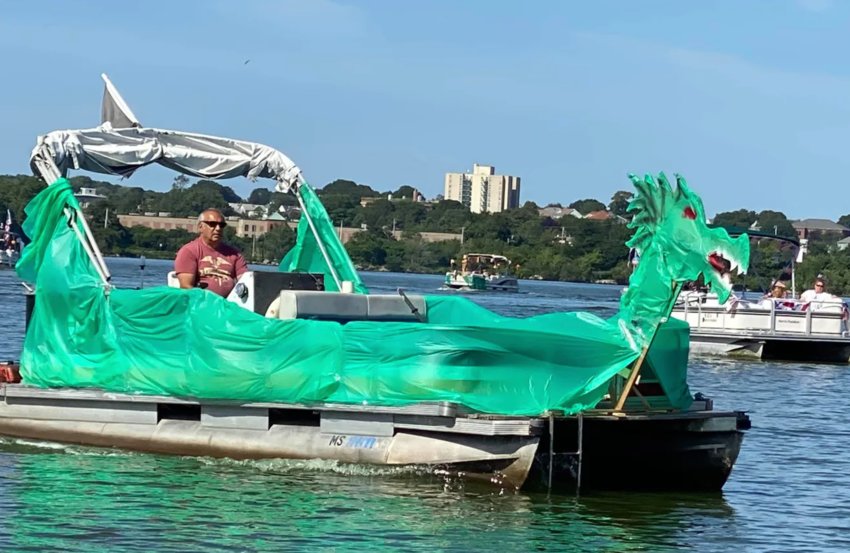 A giant green dragon boat under sail at a previous Watuppa boat parade.