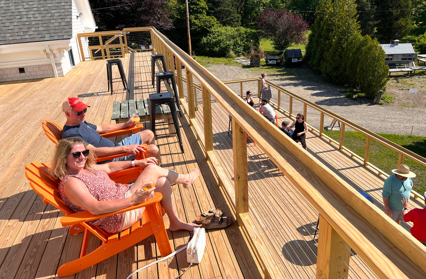 Cindy and John Bowdren enjoy a brew on the top deck at Ragged Island Brewing Company. The farm brewery will host the Ocean State Beer Festival on Sunday, Aug. 21.