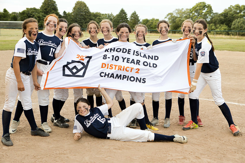 Members of the District 2 Championship team display the banner on Friday, following their 10-9 win over Portsmouth.