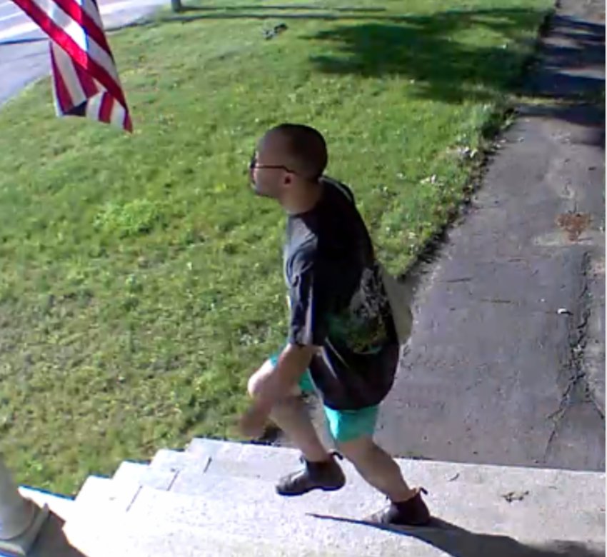 An individual later identified as Joseph Sands is shown in surveillance footage taking an American flag from a County Road resident's home late last month.