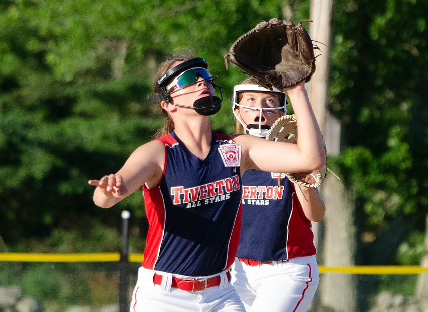 Shortstop Elodie Cannon (left) calls off second baseman Brooke Sowa before catching a fly ball.
