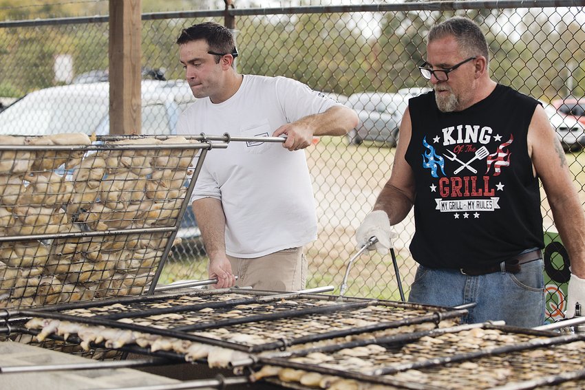 Volunteers man the chicken dinner grills during last year's fair. This year, the chicken barbecue will be held Saturday evening.