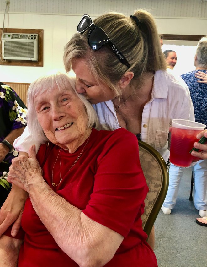 Mary Martin gets a kiss from her niece, Karen Ashton, during the former&rsquo;s 90th surprise birthday party at the FOP Lodge in Middletown on Saturday. Martin retired only 10 years ago from the fire department at the Naval Education and Training Command.