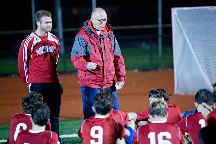 Portsmouth High School boys&rsquo; varsity soccer head coach Mike Stinton (center) talks to his team during halftime of a game in 2018. The 1968 PHS grad will be inducted into the PHS Athletic Hall of Fame on Oct. 8 as both an athlete and coach.