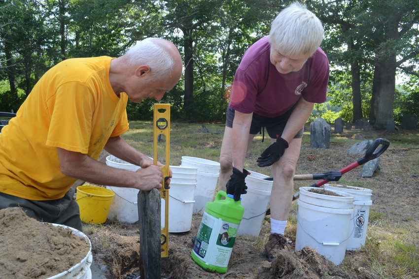 Carlo and Betty Mencucci go through the laborious process of re-seating a gravestone that had become tilted at Kickemuit Cemetery on Serpentine Road in Warren, the oldest historical cemetery in town. The couple have helped restore and conserve over 40 cemeteries throughout Rhode Island, earning widespread acclaim.