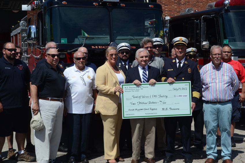 Senator Jack Reed, flanked by Town Manager Kate Michaud (to his left), Fire Chief James Sousa, and Town Planner Bob Rulli (to his right), presents a check for $2 million to assist with the construction of a new fire/rescue headquarters in Warren.