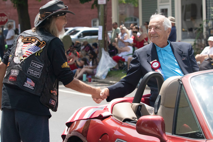 Purple Heart recipient Arthur Medeiros greets admirers during the 2021 Bristol Fourth of July Parade. Medeiros was thrice awarded the Purple Heart for injuries received in World War II, including at the Battle of the Bulge, as well as a Silver Star and a Bronze Star for his valor. The Bristol Veterans Council and VFW Post 237 are seeking Bristol&rsquo;s Purple Heart recipients for recognition, following the Town Council&rsquo;s proclamation declaring Bristol a Purple Heart Town.