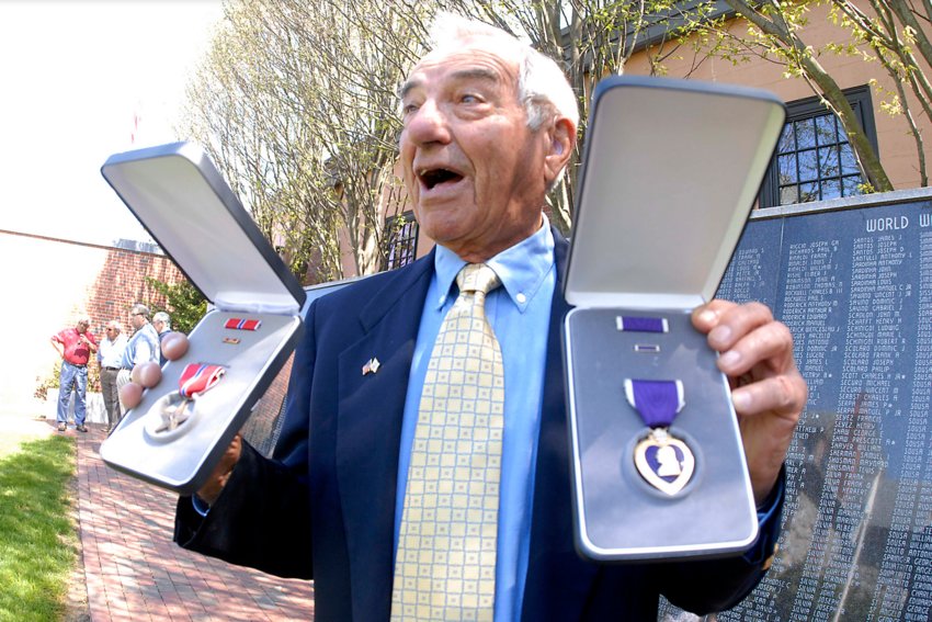Arthur Medeiros pictured in 2013, receiving his long overdue Bronze Star and one of his three Purple Hearts nearly 70 years after earning them in World War II.