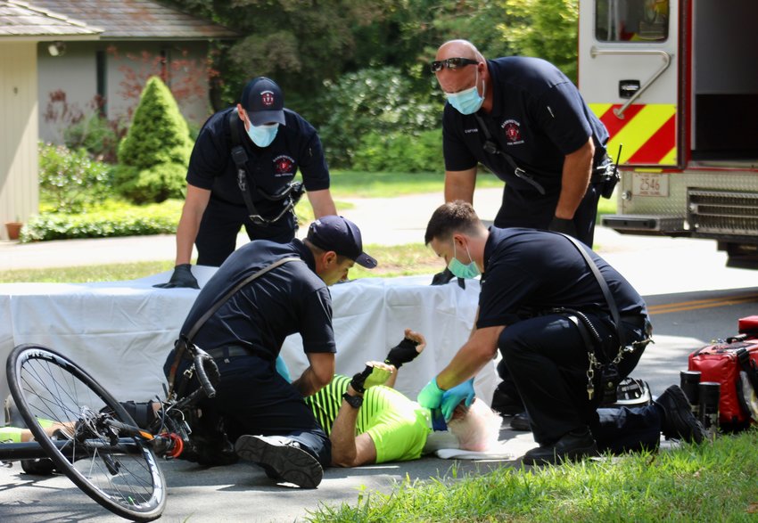 Barrington firefighters tend to an injured bicyclist last week. A vehicle struck the bicyclist at the intersection of South Lake Drive and the bike path.